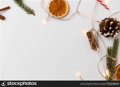 christmas, holidays and celebration concept - frame of garland lights and decorations on white background. frame of garland lights and christmas decorations