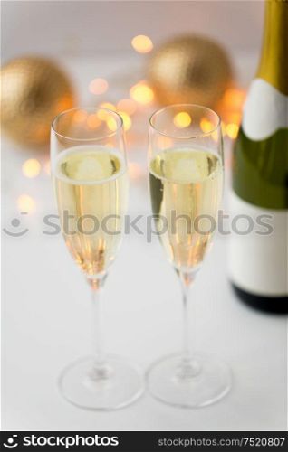 christmas, holidays and celebration concept - two glasses of champagne and decorations. two glasses of champagne on christmas