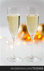 christmas, holidays and celebration concept - two glasses of champagne. two glasses of champagne on christmas