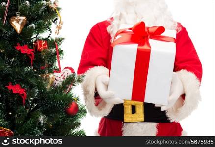 christmas, holidays and people concept - close up of santa claus with gift box and tree