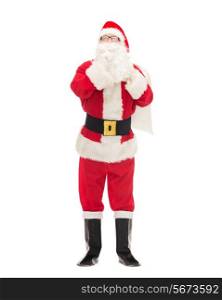 christmas, holidays and people concept - man in costume of santa claus with bag making hush gesture