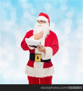 christmas, holidays and people concept - man in costume of santa claus with notepad over blue lights background