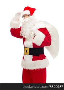 christmas, holidays and people concept - man in costume of santa claus with bag looking far away
