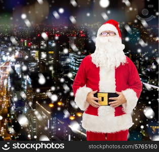 christmas, holidays and people concept - man in costume of santa claus over snowy night city background