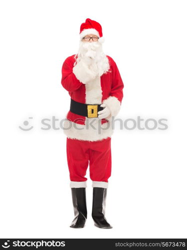 christmas, holidays and people concept - man in costume of santa claus making hush gesture