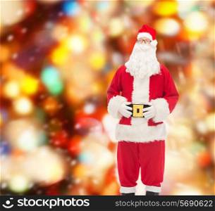 christmas, holidays and people concept - man in costume of santa claus over red lights background