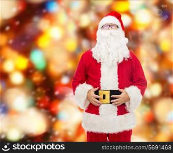 christmas, holidays and people concept - man in costume of santa claus over red lights background