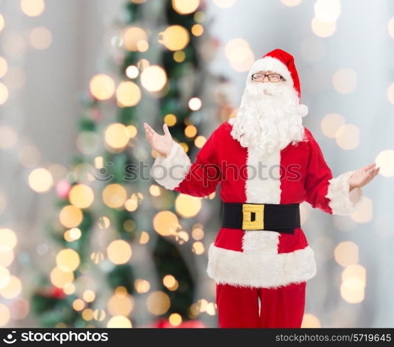 christmas, holidays and people concept - man in costume of santa claus over tree lights background