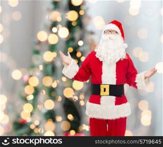 christmas, holidays and people concept - man in costume of santa claus over tree lights background