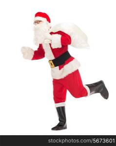 christmas, holidays and people concept - man in costume of santa claus running with bag