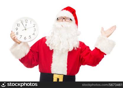 christmas, holidays and people concept - man in costume of santa claus with clock showing twelve