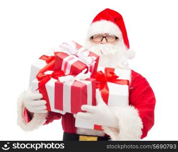 christmas, holidays and people concept - man in costume of santa claus with gift boxes