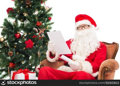 christmas, holidays and people concept - man in costume of santa claus with letter