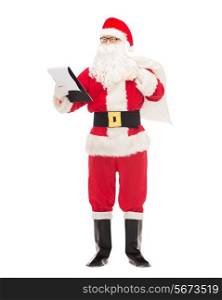 christmas, holidays and people concept - man in costume of santa claus with notepad and bag