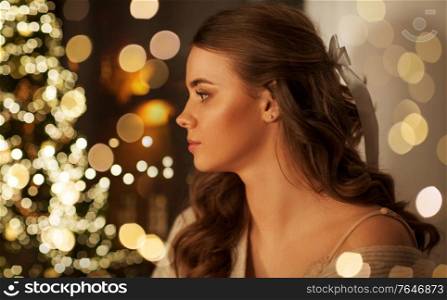 christmas, holidays and people concept - portrait of young woman at home. portrait of young woman at home on christmas