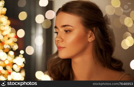 christmas, holidays and people concept - portrait of young woman at home. portrait of young woman at home on christmas