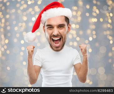 christmas, holidays and people concept - screaming man in santa hat over lights background (funny cartoon style character with big head). screaming man in santa hat over lights