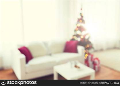 christmas, holidays, backdrop and interior concept - blurred living room with christmas tree background. blurred living room with christmas tree background
