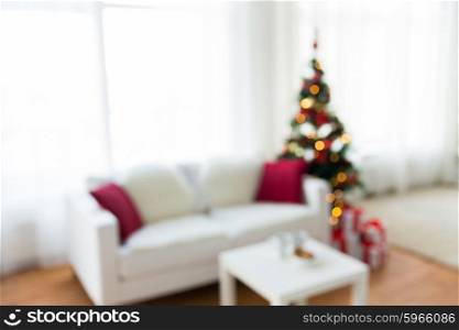 christmas, holidays, backdrop and interior concept - blurred living room with christmas tree background