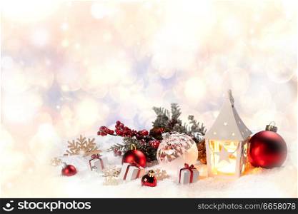 Christmas holidays card with gifts , balls , santa claus hat and glowing lantern in snow. Christmas decor in snow
