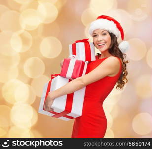 christmas, holidays, celebration and people concept - smiling woman in red dress with gift boxes over beige lights background