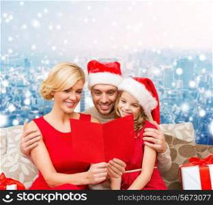 christmas, holidays, family and people concept - happy mother, father and little girl in santa helper hats with gift boxes over snowy city background