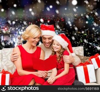 christmas, holidays, family and people concept - happy mother, father and little girl in santa helper hats with gift boxes over snowy night city background
