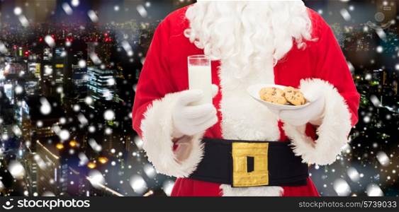 christmas, holidays, food, drink and people concept - close up of santa claus with glass of milk and cookies over snowy night city background