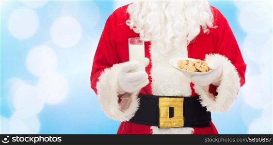christmas, holidays, food, drink and people concept -close up of santa claus with glass of milk and cookies over blue lights background