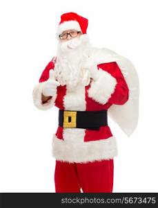 christmas, holidays, gesture and people concept - man in costume of santa claus with bag showing thumbs up