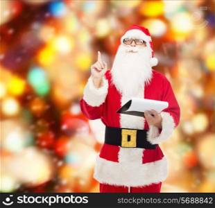 christmas, holidays, gesture and people concept - man in costume of santa claus with notepad pointing finger up over red lights background