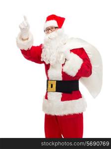 christmas, holidays, gesture and people concept - man in costume of santa claus with bag pointing finger up