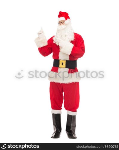 christmas, holidays, gesture and people concept - man in costume of santa claus pointing fingers
