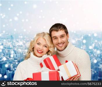 christmas, holidays, happiness and people concept - smiling man and woman with presents over snowy city background