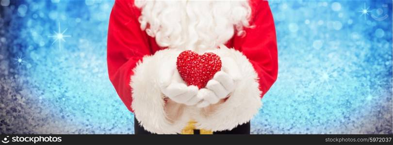 christmas, holidays, love, charity and people concept - close up of santa claus with heart shape decoration over lights or blue glitter background