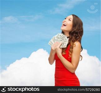 christmas, holidays, sale, banking and people concept - smiling woman in red dress with us dollar money over blue sky and cloud background