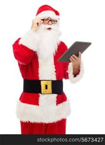 christmas, holidays, technology and people concept - man in costume of santa claus with tablet pc computer