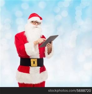 christmas, holidays, technology and people concept - man in costume of santa claus with tablet pc computer over blue lights background
