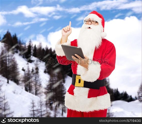 christmas, holidays, technology and people concept - man in costume of santa claus with tablet pc computer pointing finger up over snowy mountains background