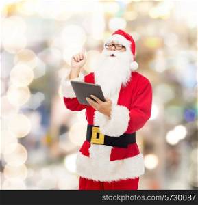 christmas, holidays, technology and people concept - man in costume of santa claus with tablet pc computer pointing finger up over lights background