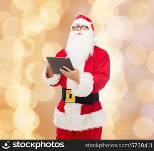 christmas, holidays, technology and people concept - man in costume of santa claus with tablet pc computer over beige lights background