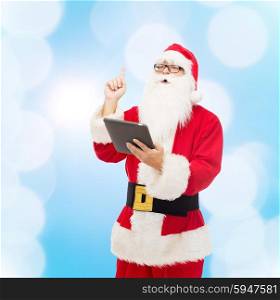 christmas, holidays, technology and people concept - man in costume of santa claus with tablet pc computer pointing finger up over blue lights background