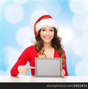 christmas, holidays, technology and people concept - smiling woman in santa helper hat with tablet pc computer over blue lights background