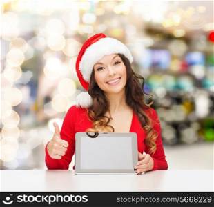 christmas, holidays, technology and people concept - smiling woman in santa helper hat with tablet pc computer showing thumbs up over lights background