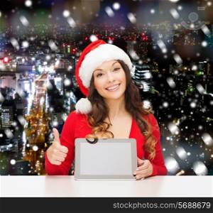 christmas, holidays, technology and people concept - smiling woman in santa helper hat with tablet pc computer showing thumbs up over snowy night city background