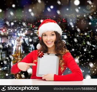 christmas, holidays, technology and people concept - smiling woman in santa helper hat with tablet pc computer over snowy night city background
