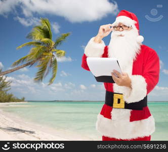 christmas, holidays, travel and people concept - man in costume of santa claus with notepad over tropical beach background