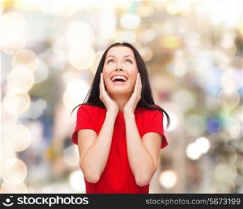 christmas, holidays, valentine&#39;s day, celebration and people concept - smiling woman in red dress over lights background