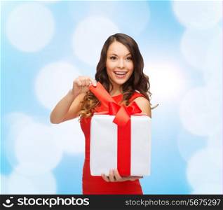 christmas, holidays, valentine&#39;s day, celebration and people concept - smiling woman in red dress with gift box over blue lights background
