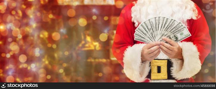 christmas, holidays, winning, currency and people concept - close up of santa claus with dollar money over lights background